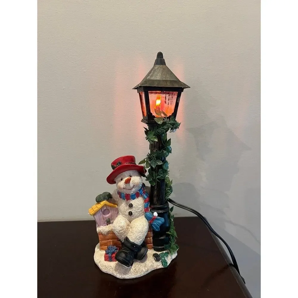 Snowman with flickering street lamp